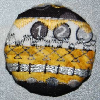 Design knapper af ægkanter og frit maskinbroderi. Håndværk og design.