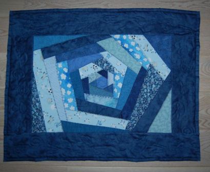 Baby-tæppe med crazy patchwork og quiltet motiver.